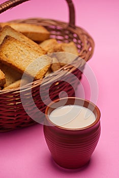 Rusks in a basket and tea in mud glass