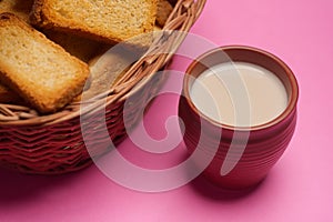 Rusks in a basket and tea in mud glass