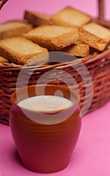 Rusks in a basket and tea in mud glass