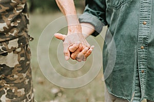 Russia, 07.04.2021. happy senior couple holding hands. hands of man and woman hold each other. romance and love and support in eld