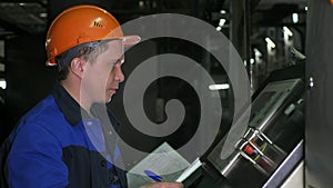 RUSSIA, ANGARSK - JUNE 8, 2018: Operator monitors control panel of production line. Manufacture of plastic water pipes