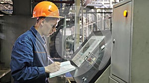 RUSSIA, ANGARSK - JUNE 8, 2018: Operator monitors control panel of production line. Manufacture of plastic water pipes