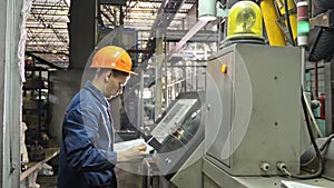 RUSSIA, ANGARSK - JUNE 8, 2018: Operator monitors control panel of production line. Manufacture of plastic water pipes