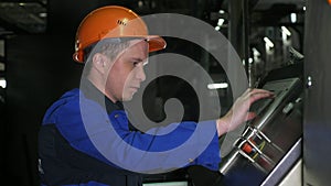 RUSSIA, ANGARSK - JUNE 8, 2018: Operator monitors control panel of production line. Manufacture of plastic water pipes