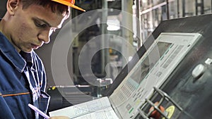 RUSSIA, ANGARSK - JUNE 8, 2018: Operator monitors control panel of production line. Manufacture of plastic water pipes