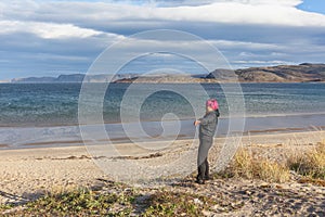 Russia, Arctic, Kola Peninsula, Teriberka: woman lays her back on the wind, gale