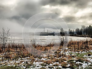 Russia - Arkhangelsk - frozen suburb lake at foggy winter day