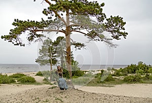 On the coast of the White Sea, a girl swinging on a swing.