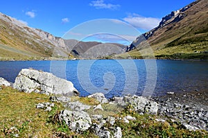 Russia, Arkhyz. Lake Zaprudnoye in autumn in sunnny day