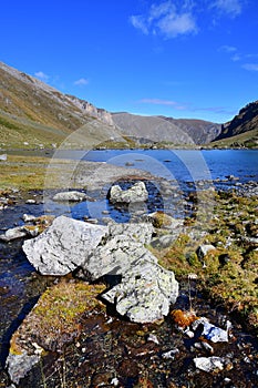 Russia, Arkhyz. Lake Zaprudnoye in autumn in sunnny day