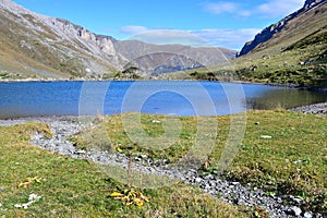 Russia, Arkhyz. Lake Zaprudnoye in autumn in sunnny day