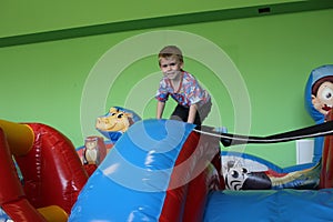 Russia, a cheerful little boy plays in a playground with attractions for a child