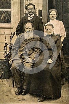 RUSSIA - CIRCA 1905-1910: Shot of elderly married couple with their adult son and daughter in studio , Vintage Carte de Viste