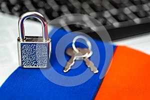 Russia cyber security concept. Padlock on computer keyboard and Russian flag. Close-up view photo