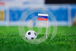 Russia Flag and football ball on green grass. Photo, copy space