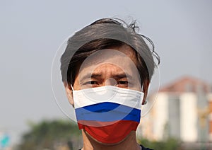 Russia flag on hygienic mask. Masked man prevent germs. concept of Tiny Particle protection or virus corona Covid 19 protection
