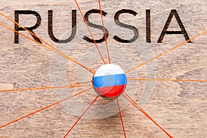 Russia flag on the pin with red thread showed the paths on the wooden map.