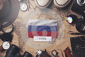 Russia Flag Between Traveler`s Accessories on Old Vintage Map. Overhead Shot