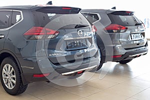 Russia, Izhevsk - February 19, 2021: New modern X-Trail cars in the Nissan showroom. Back and side view. Famous world brand