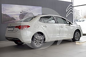 Russia, Izhevsk - March 4, 2022: Citroen showroom. New modern Citroen C4 sedan car in dealer showroom. Back and side