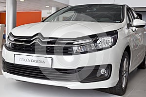 Russia, Izhevsk - March 4, 2022: Citroen showroom. New modern Citroen C4 sedan car in dealer showroom. Front view