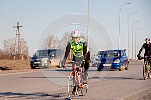 Russia Kemerovo 2019-04-11 Cycling competition, cyclist athletes in helmet and uniform tinkoff team riding race at high speed on