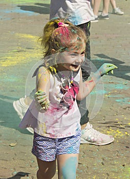 Russia, Krasnoyarsk, June 2019: a little girl at the festival of colors Holi