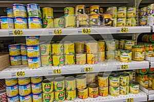 RUSSIA, MOSCOW, JUNE 11, 2017: Different types of canned corn on the shelves in the supermarket Auchan