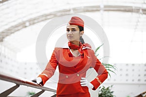 RUSSIA, MOSCOW: 28 JUNE 2019. Young stewardess dressed in official red uniform of Aeroflot Airlines on airport photo