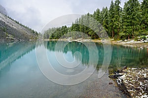 Russia, Mountain Altai. The shore of Shavlinskoye lake covered with snow in August, 22, 2016