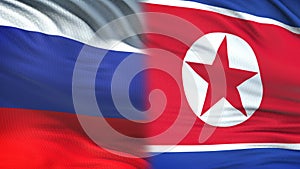 Russia and North Korea officials exchanging confidential envelope, against flags