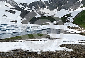 Russia, North Ossetia. Mountain lake Dzedo East Zrug, Zrugskoye, Zrugskoe in  cloudy July day