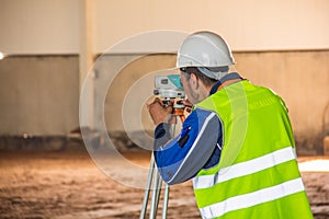 Surveyor work with a total station when building a factory