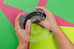 Russia, OCTOBER 24 2019: Male hands holding a PS4 controller, Sony PlayStation 4 game console