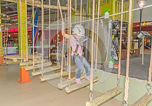 Russia, Saint-Petersburg, adventure Park, adventure Gornostay 27 Oct 2017 girl on the obstacle course wearing a helmet and