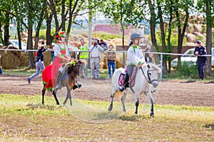 Samara, August 2018: Children in Russian national costumes sit on a pony