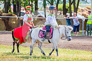 Samara, August 2018: Children in Russian national costumes sit on a pony