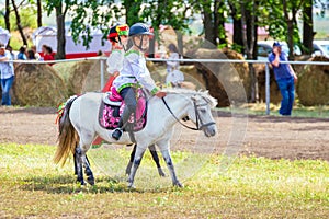 Samara, August 2018: Children in Russian national costumes sit on a pony