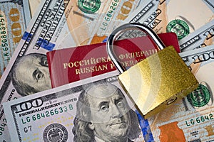 Russia Sanctions and Ukraine war concept. Russian Federation passport, padlock on american dollars. Currency ban in Russia