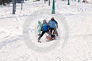 Ski rescuer is carrying an empty cradle down the mountain. concept of dangerous skating, freeride, rescue injured skier