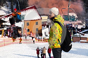 Russia, Sheregesh 2018.11.17 Snowboarders and skiers in the mountain resort, small cute chalets, cafes, funicular. The concept