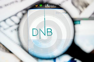 RUSSIA, ST.PETERSBURG - August 12, 2020: DnB ASA logo on the website screen through a magnifier