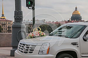 Russia, St. Petersburg, city streets, road transport, wedding car close-up, in the background the golden dome of St. Isaac`s Cathe