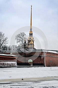 Russia, St. Petersburg, January 2021. The walls of the Peter and Paul Fortress and the spire of the cathedral over the river.