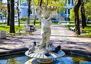 Russia, St. Petersburg - May 5, 2023: Statue of a boy, a fountain in a city park