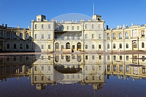 Russia, suburb of St. Petersburg. Great Gatchina Palace 1766 - 1781 and parade-ground. Reflection in pools after a rain