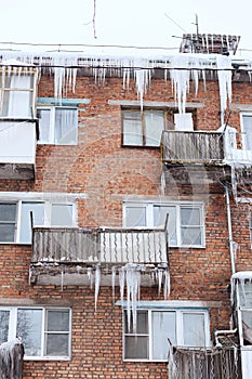 Russia. Terrible huge icicles formed on the balcony of a multi-storey building due to a poor roof storm system