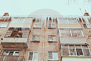 Russia. Terrible huge icicles formed on the balcony of a multi-storey building due to a poor roof storm system