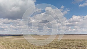 Russia, timelapse. The movement of clouds over the fields of winter wheat in early spring in the vast steppes of the Don.