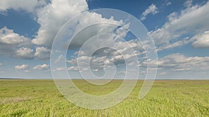 Russia, timelapse. The movement of clouds over the fields of winter wheat in early spring in the vast steppes of the Don.